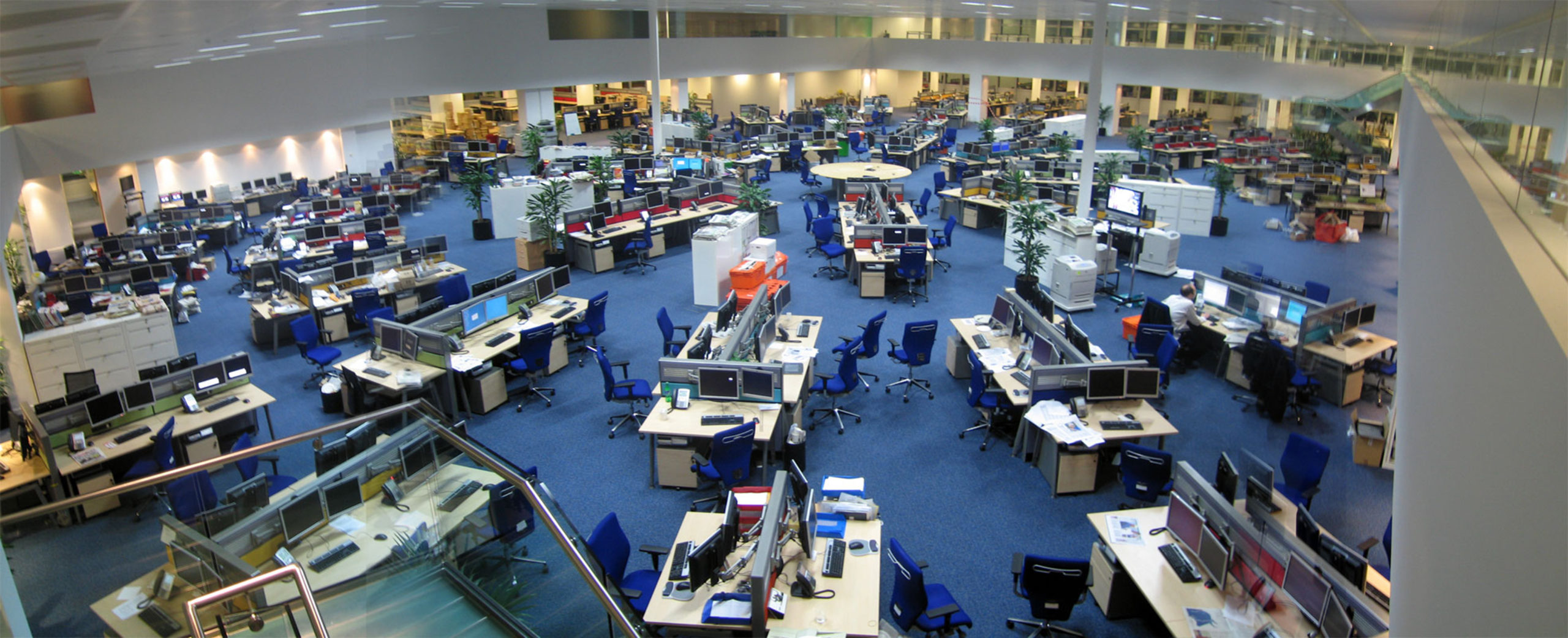 A large open news room with enough space to seat about 200 employees.
